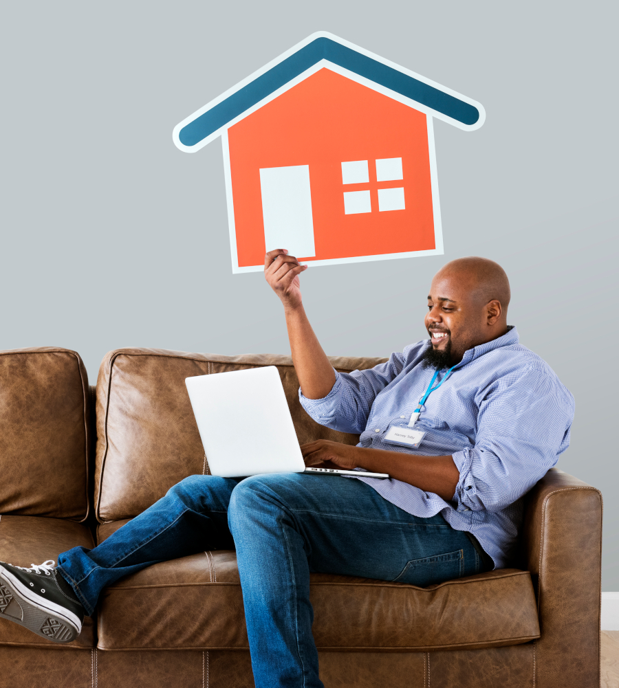 Man showing house icon on couch